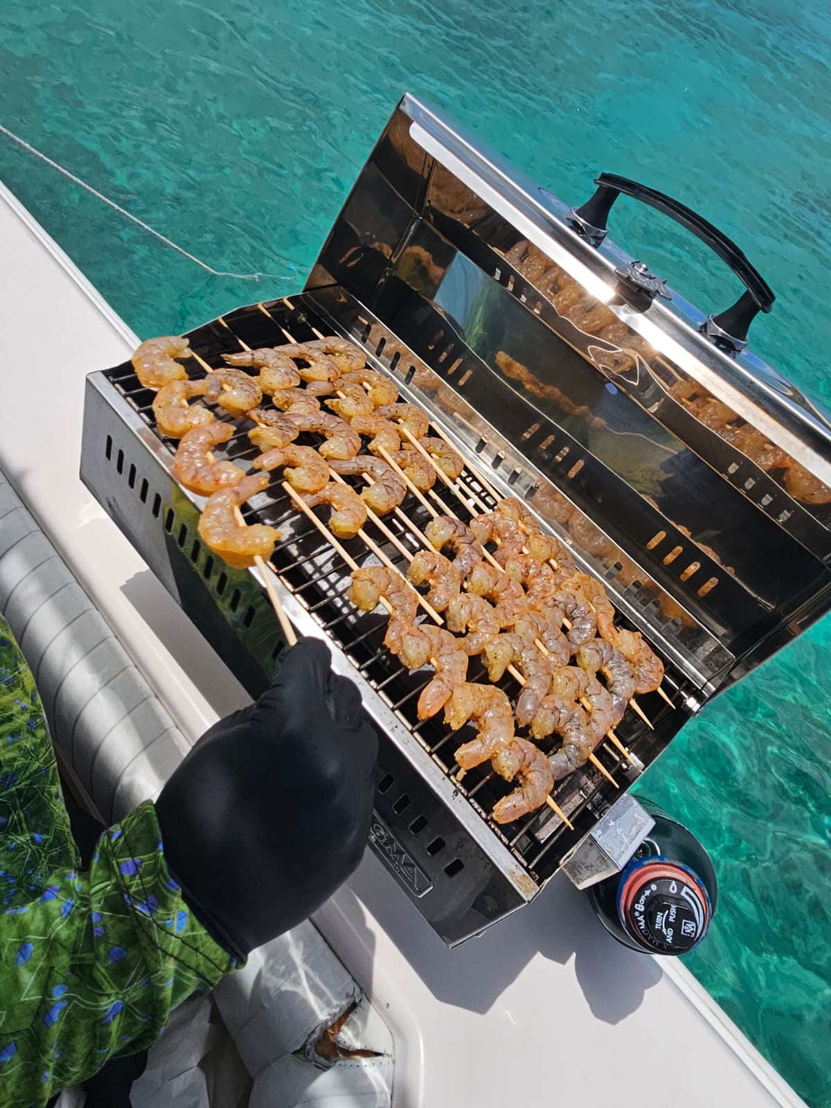 Fresh shrimp skewers cooking on the marine grill onboard a Boating Puerto Rico charter