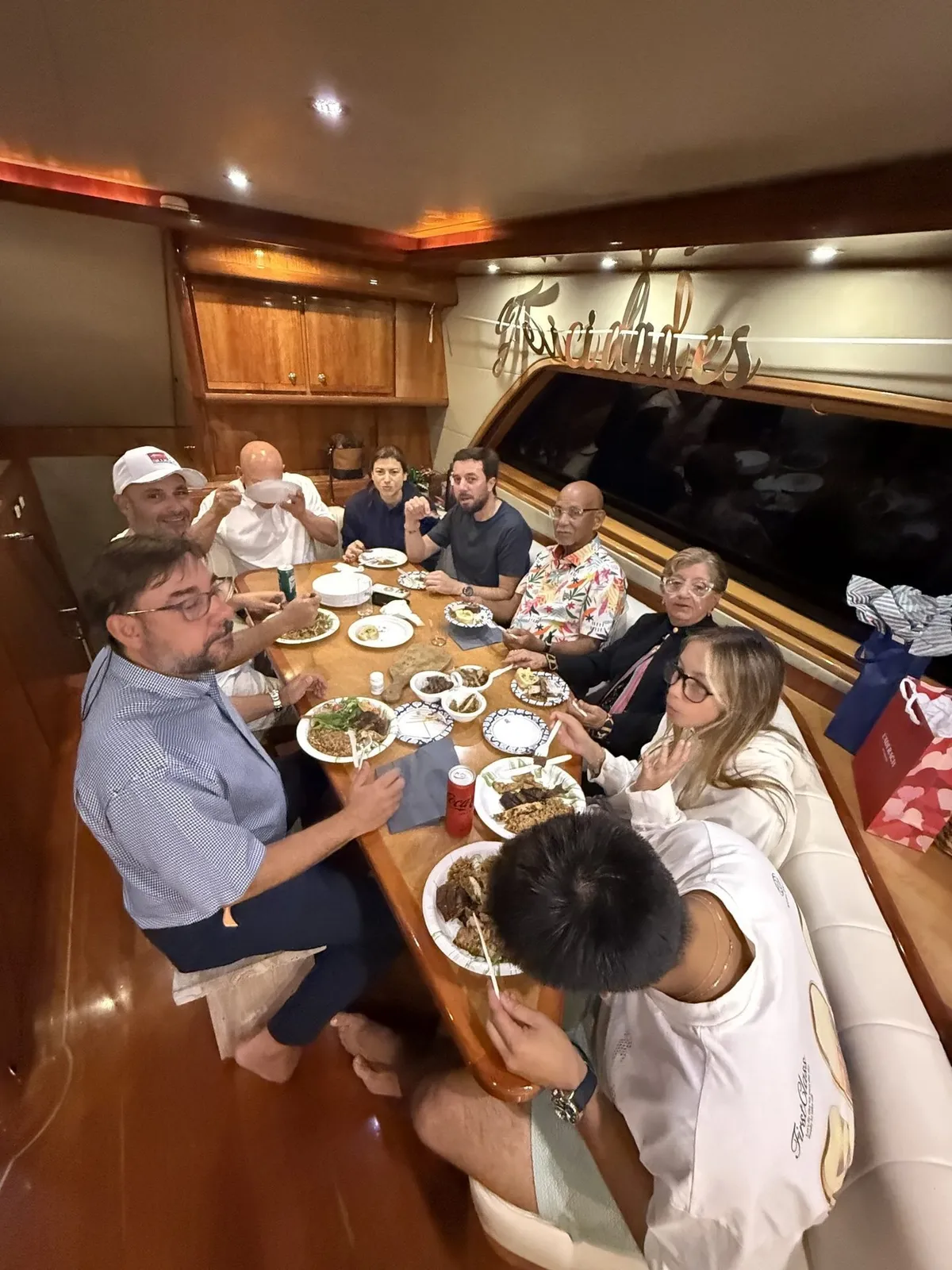 Guests enjoying a private plated dinner inside the Bertram 70 salon at San Juan Bay Marina, Puerto Rico