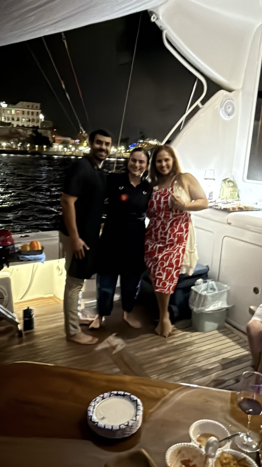 Guests aboard the Bertram 70ft yacht rental at night in San Juan