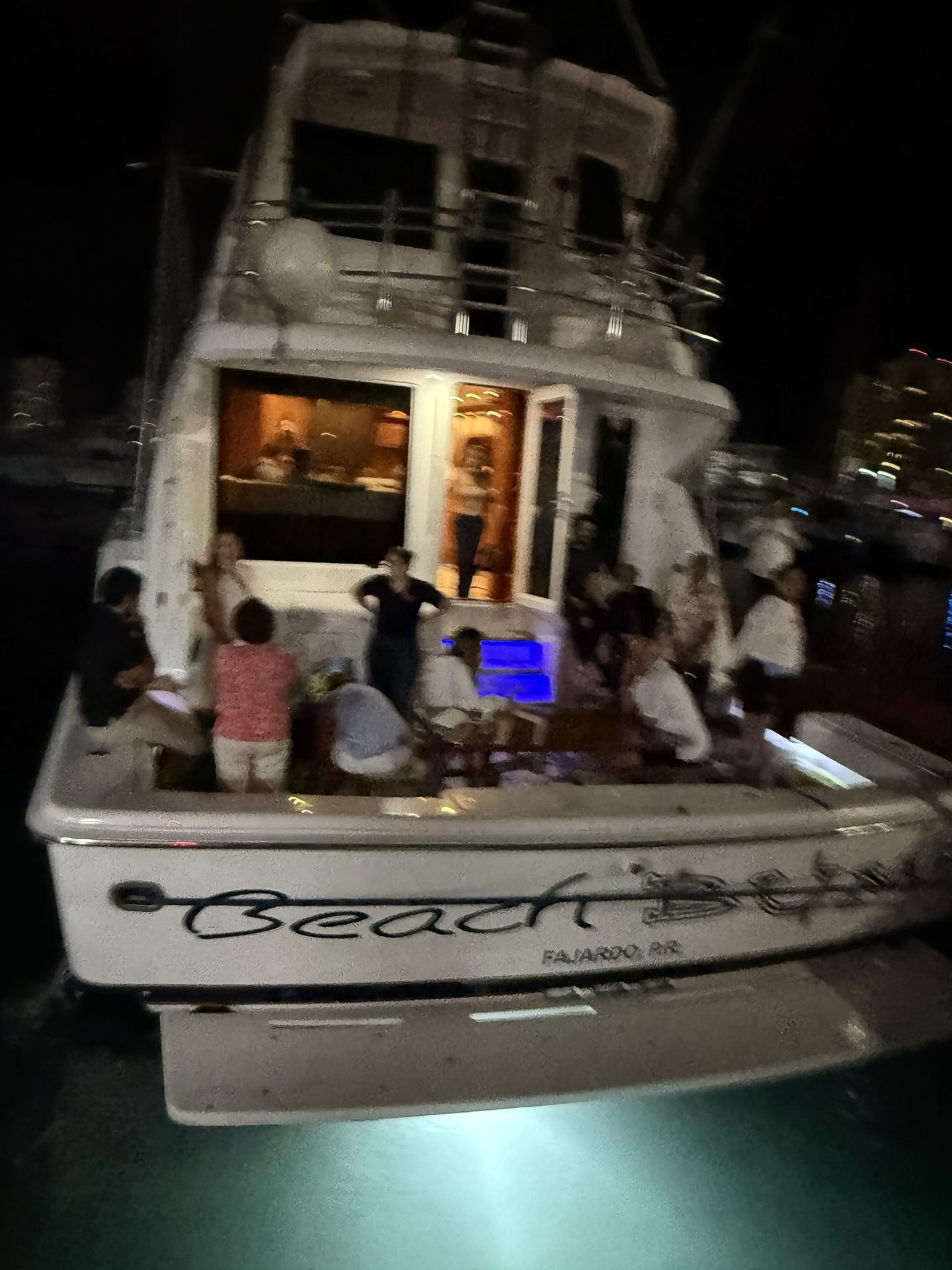 Bertram 70ft yacht stern lit up at night, San Juan Bay Marina
