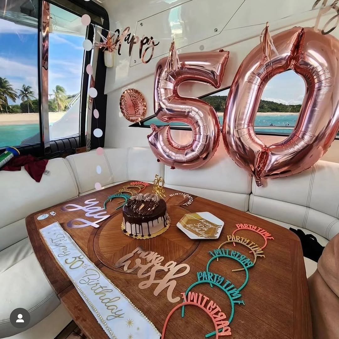 50th birthday rose gold decorations and cake onboard a yacht