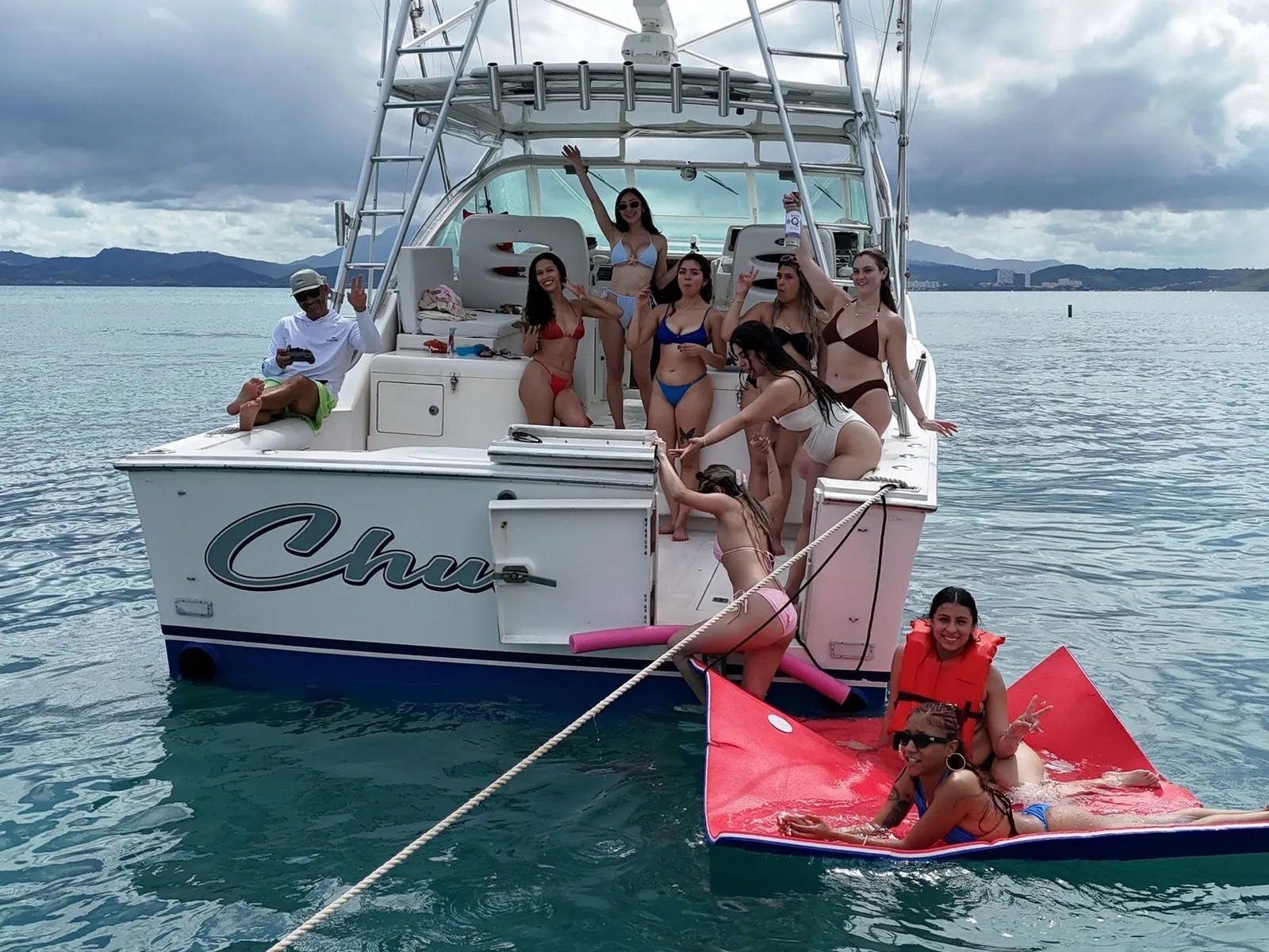 Bachelorette party group celebrating on private yacht in turquoise water Puerto Rico