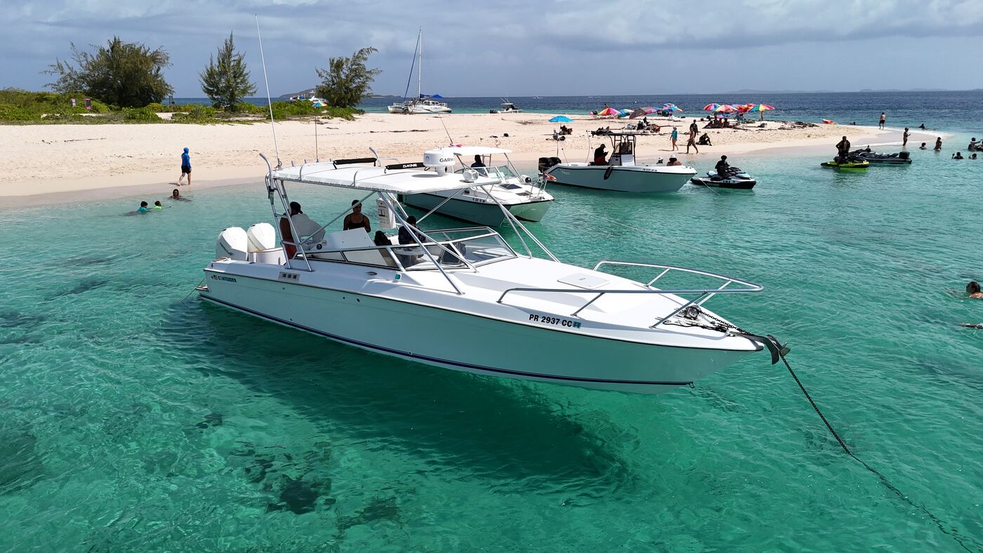 Contender 38 with guests aboard anchored in turquoise water off a white sand cay near Fajardo, Puerto Rico