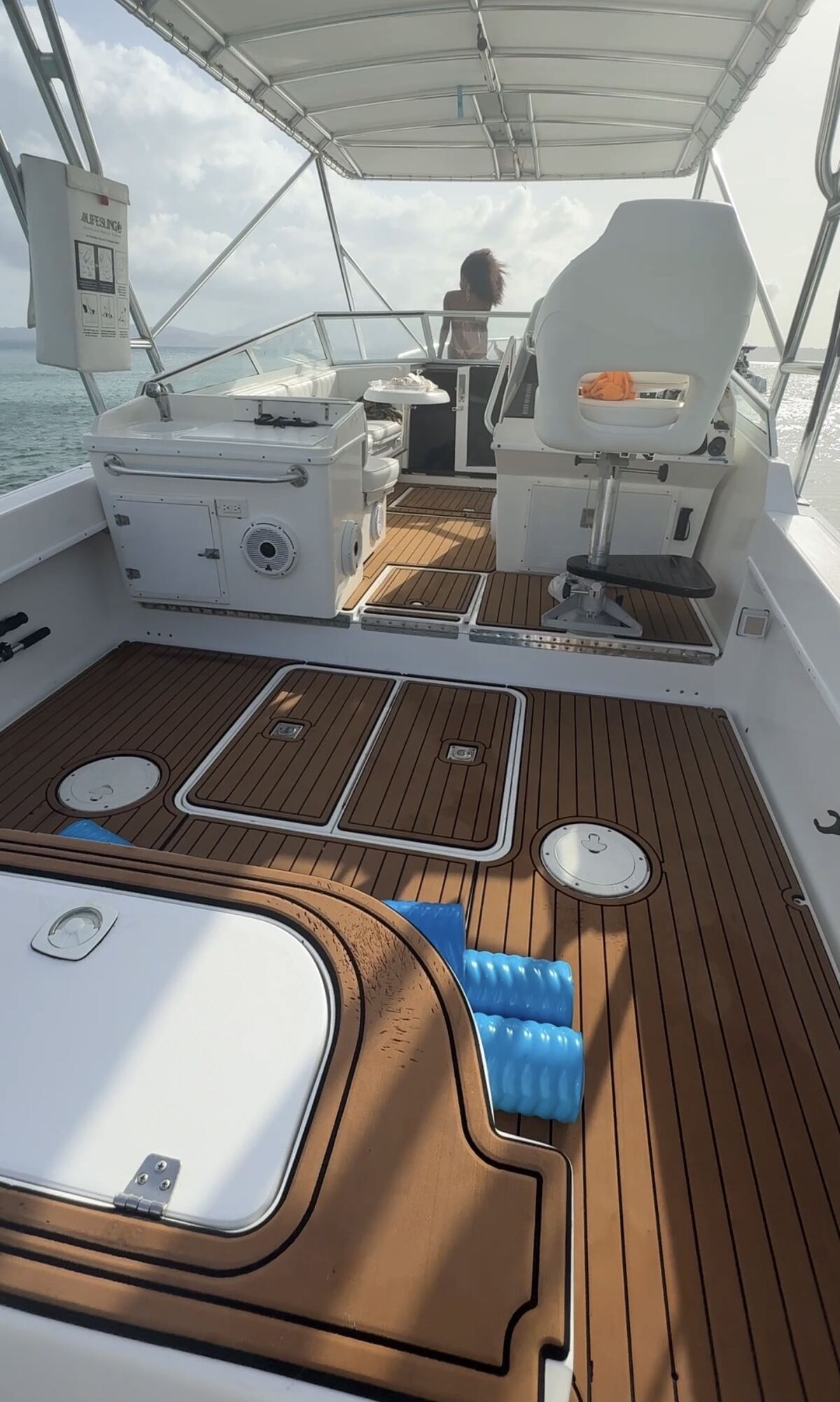 Synthetic teak aft deck of the Contender 38 with helm seat, cooler and service station and speakers, ready for up to 12 guests