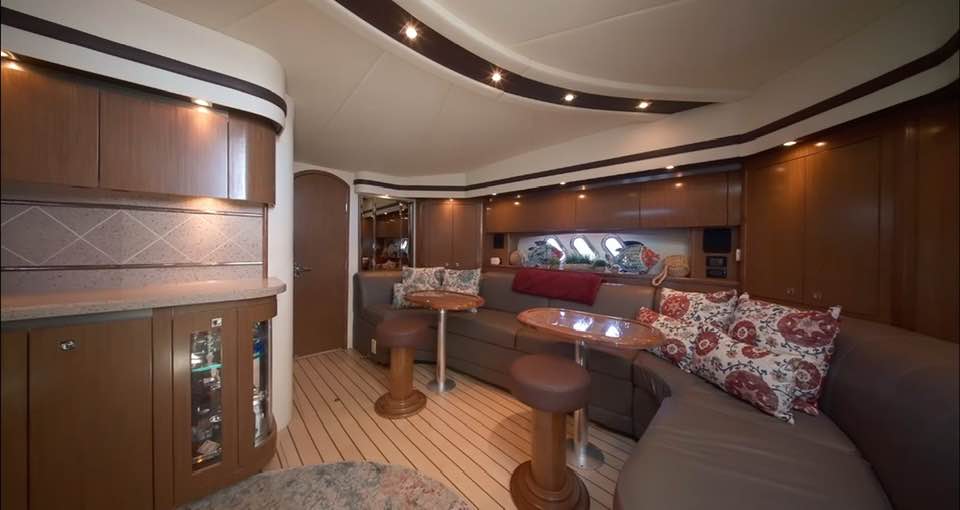 Cruiser Yachts 60 interior salon with full wet bar, U-shaped seating, and climate control