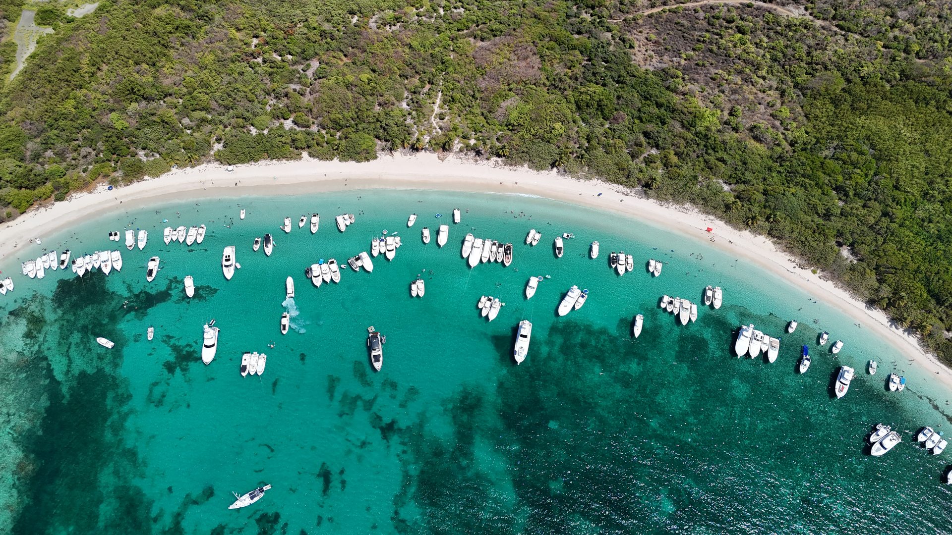 Aerial drone shot of Flamenco Beach arc Culebra Puerto Rico with boats anchored