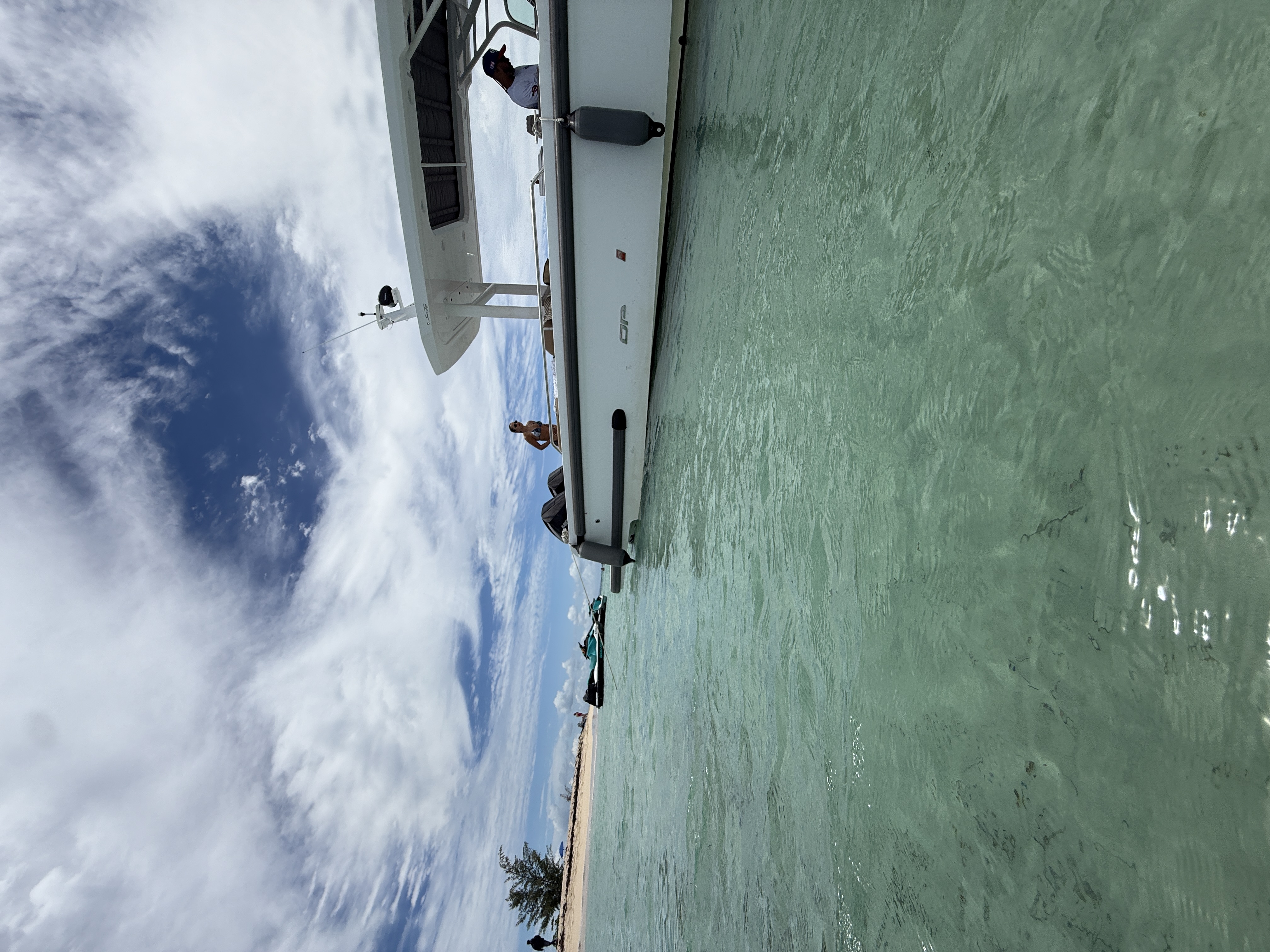 Side view of Axopar yacht from the water with sandbar in background