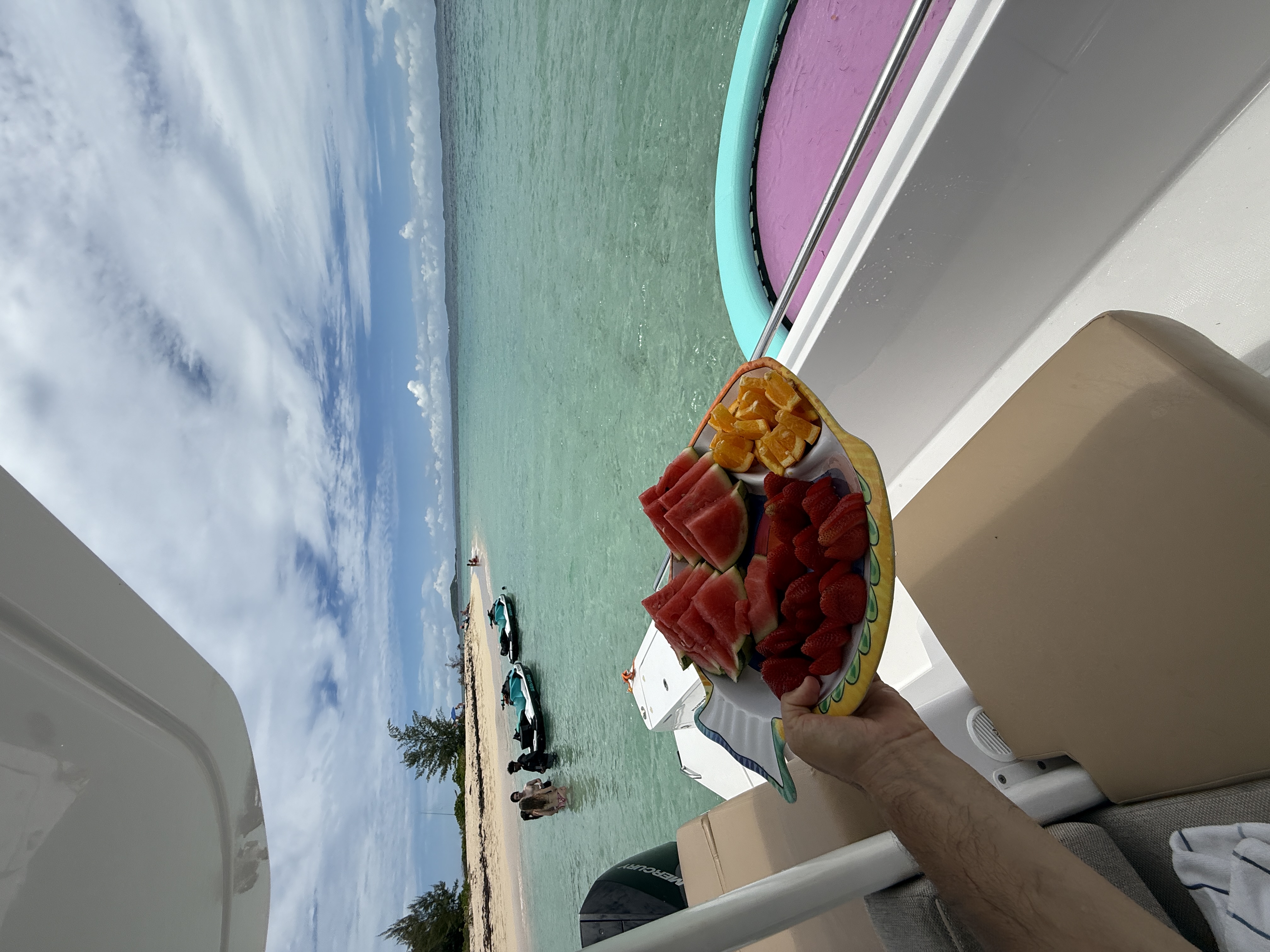 Fresh fruit platter served on yacht — watermelon, strawberries, oranges