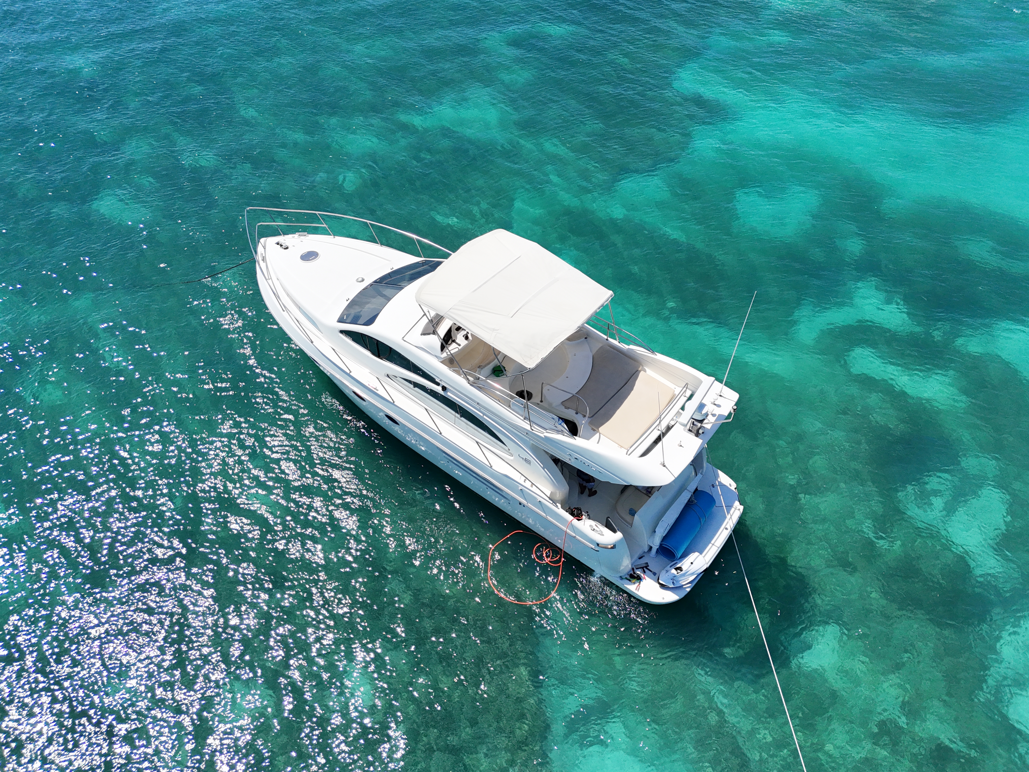 Top-down aerial of Azimut yacht in turquoise Caribbean water