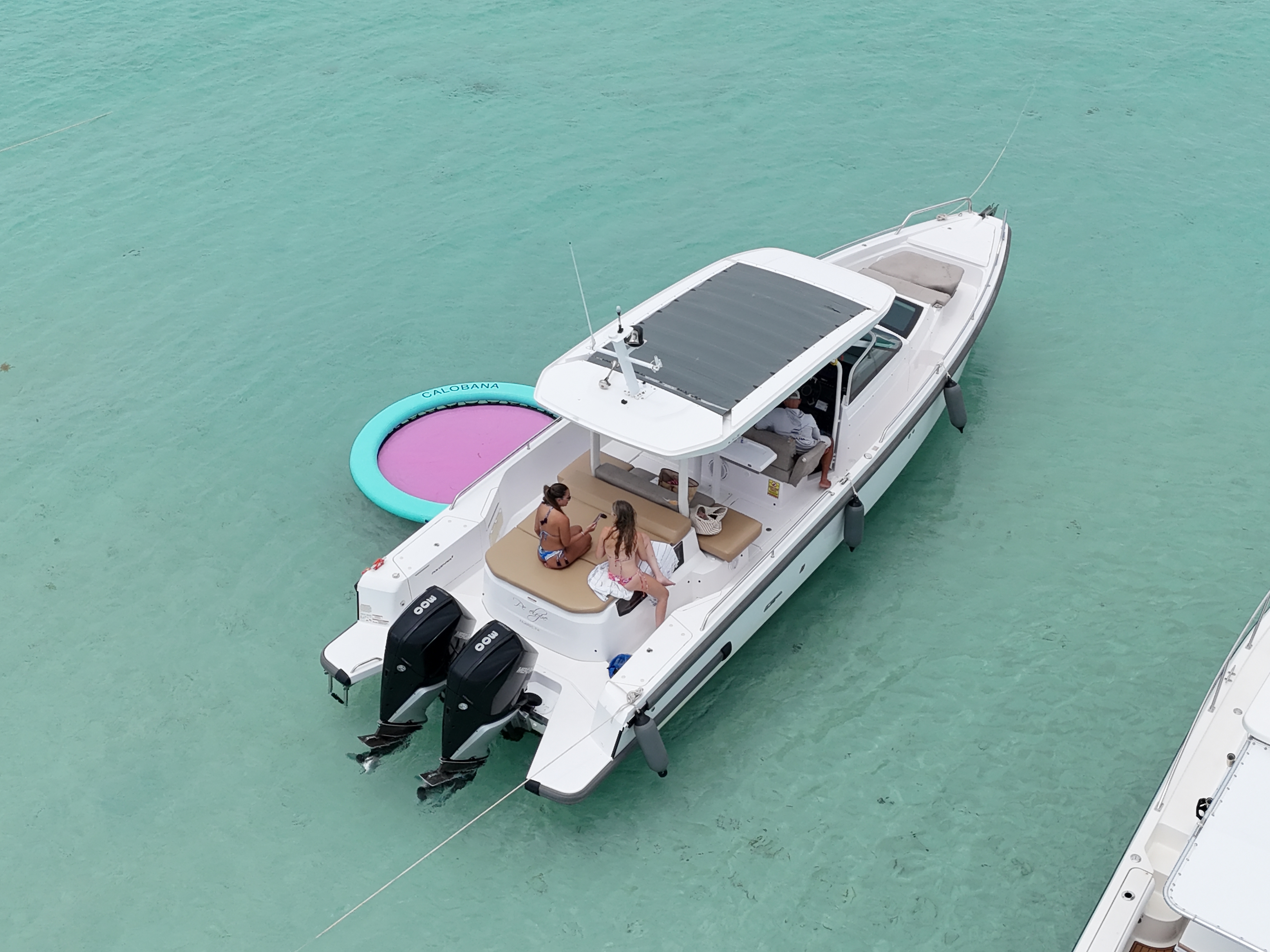 Aerial drone view of Axopar in clear Caribbean waters with Calobana mat