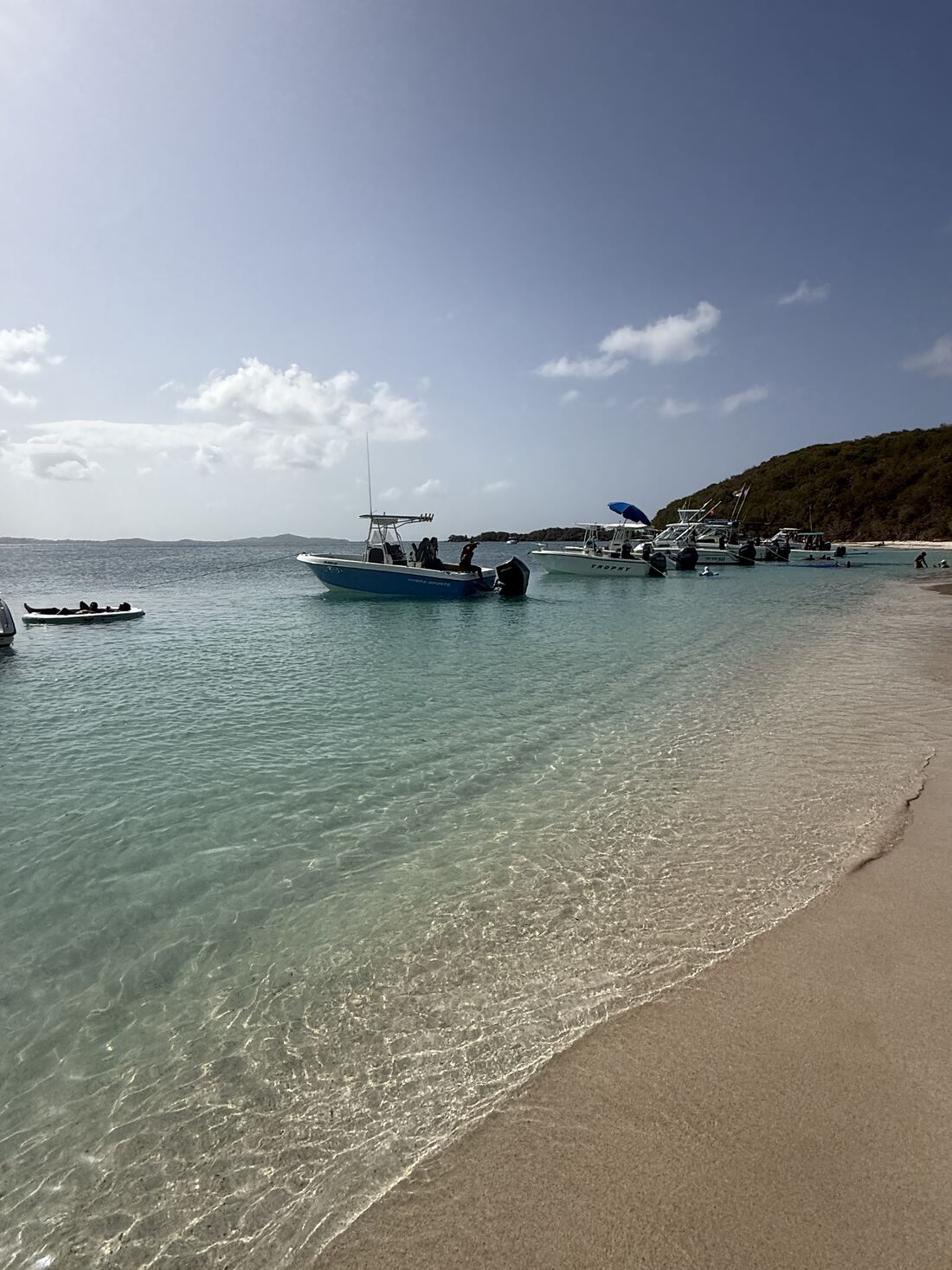 Center console boat anchored off a white sand beach on a private charter in Puerto Rico