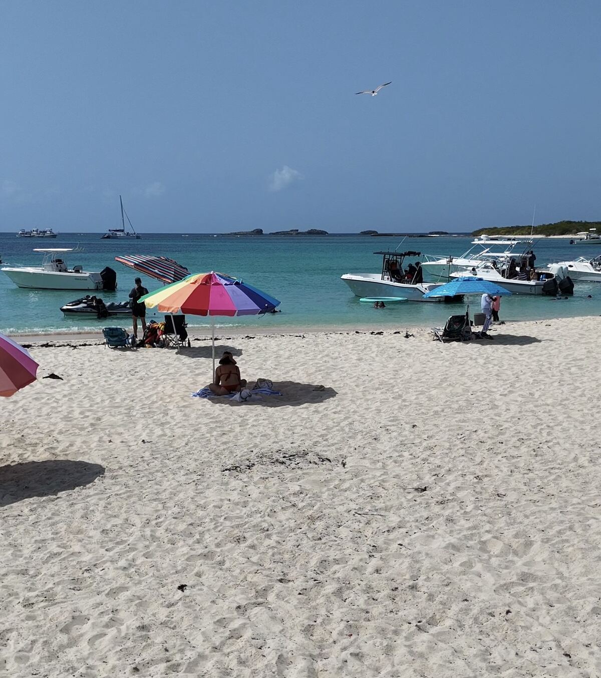 Beachgoers, colourful umbrellas and center console boats along the shore at Icacos Island, a short run from Fajardo, Puerto Rico