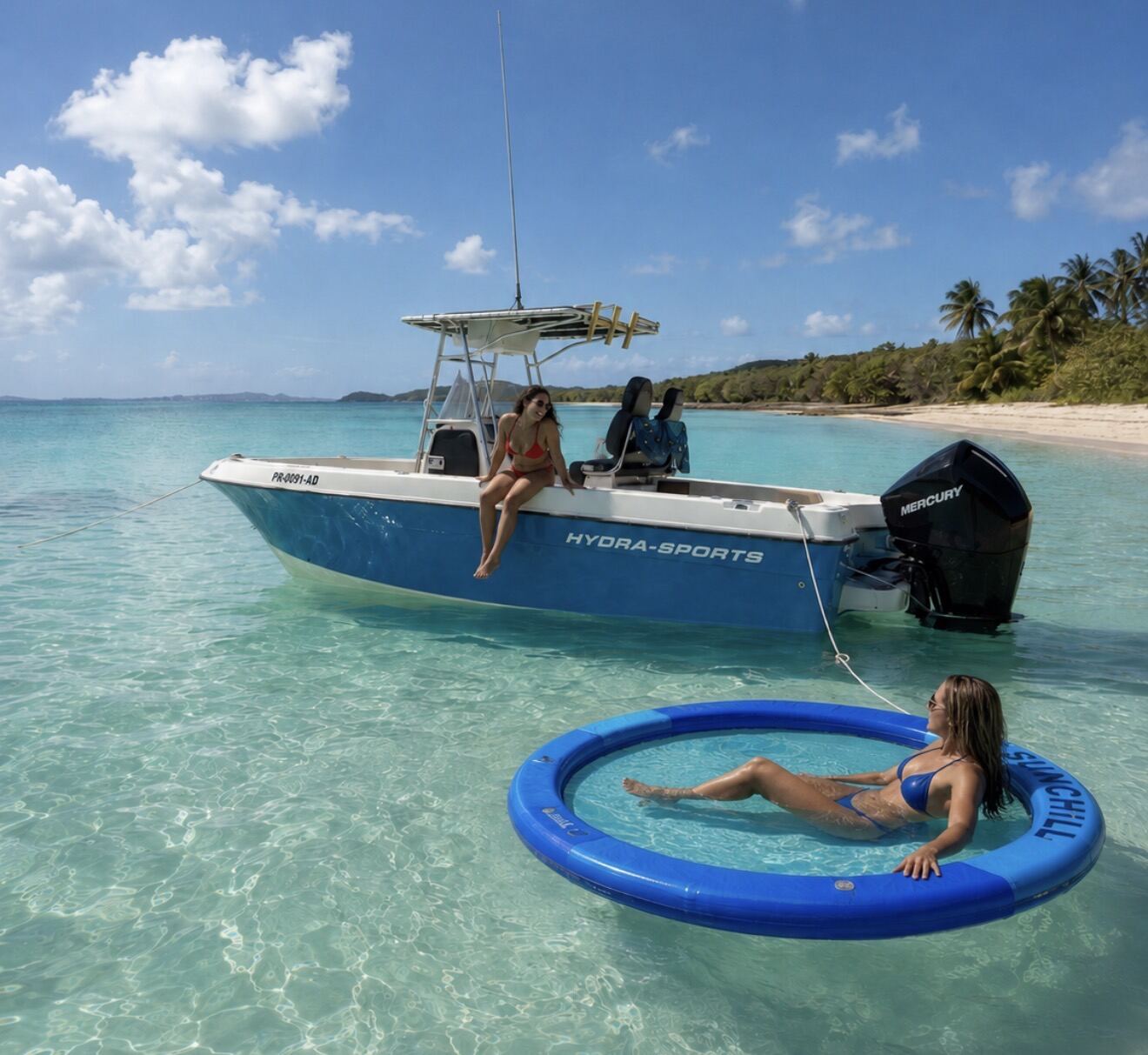 Guests relaxing on the Hydra Sport 25ft with the floating mat in the water off Icacos, Puerto Rico