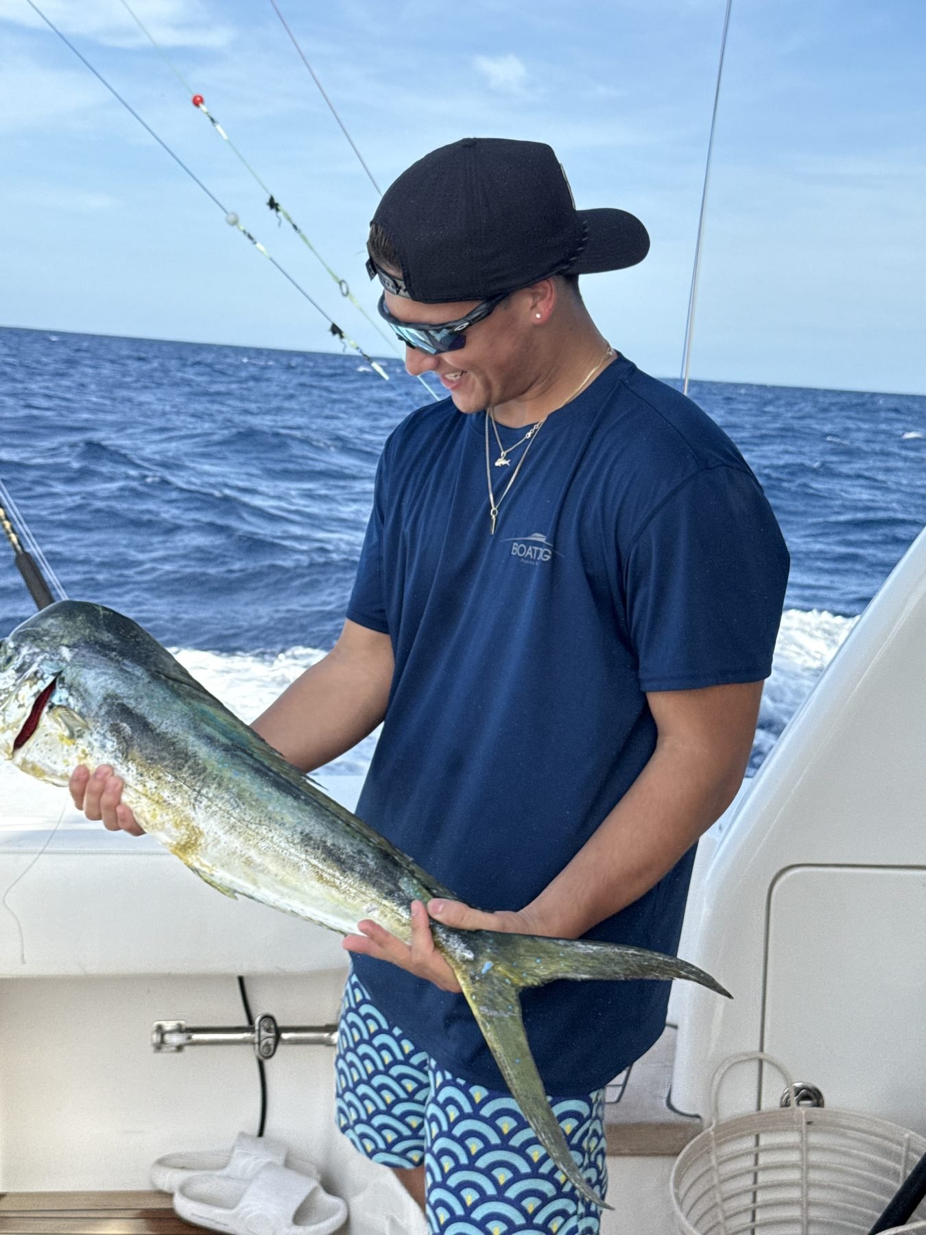 Angler with a mahi-mahi catch wearing Boating Puerto Rico shirt