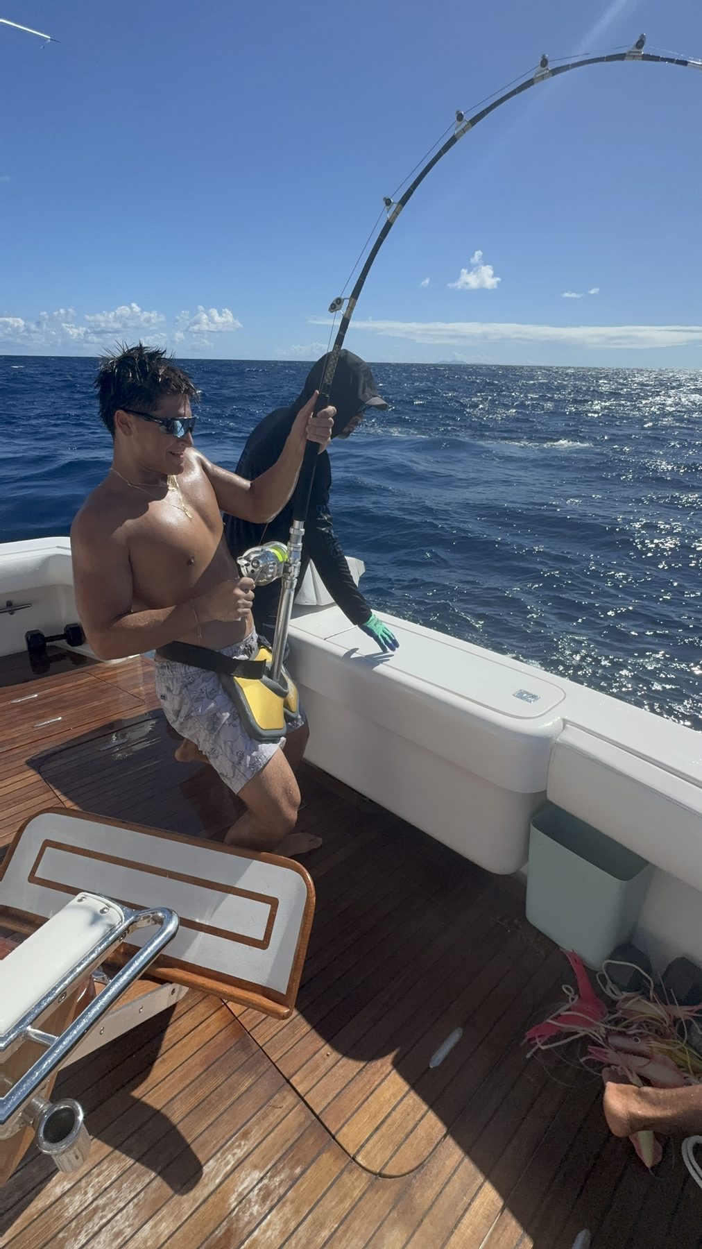 Angler fighting a fish from the fighting chair, rod bent over