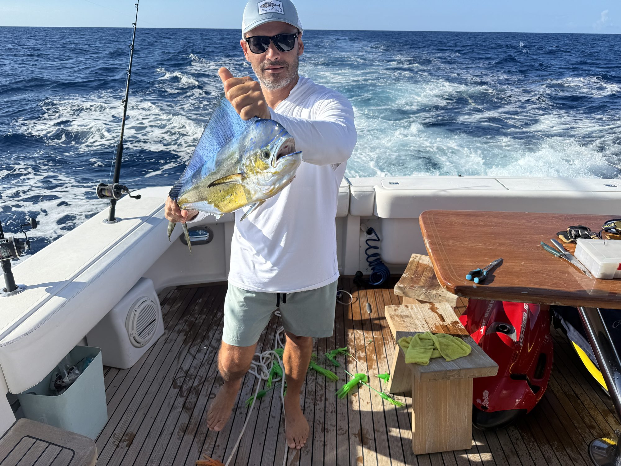 Captain holding a mahi caught off the San Juan coast on the Bertram 70 fishing charter