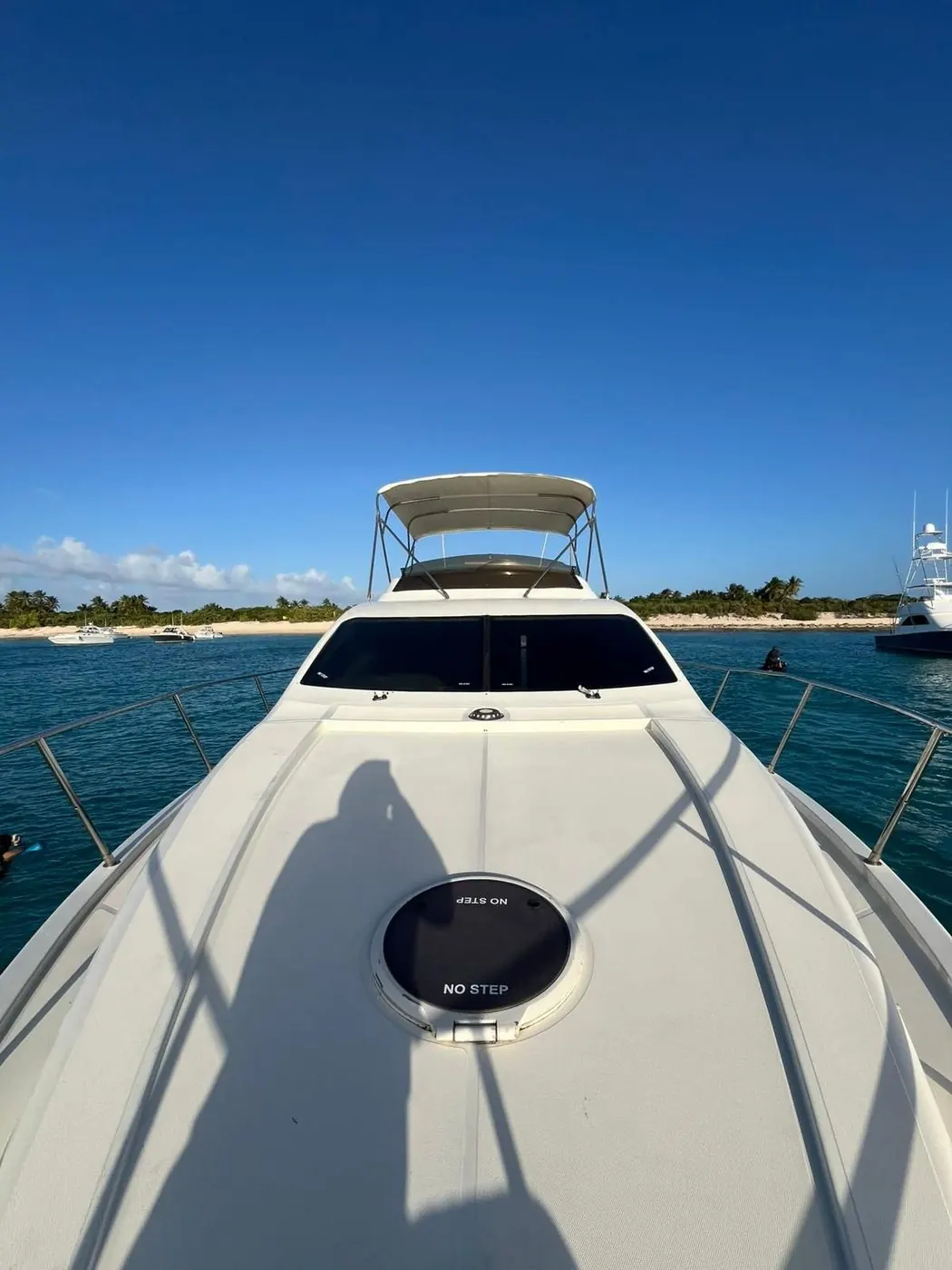 Bow view with bimini and beach backdrop