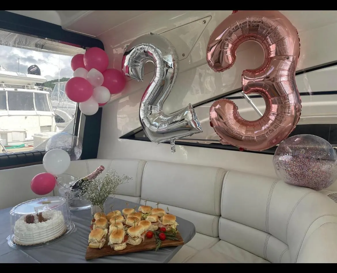 Yacht decorations setup with balloons, cake and celebration spread