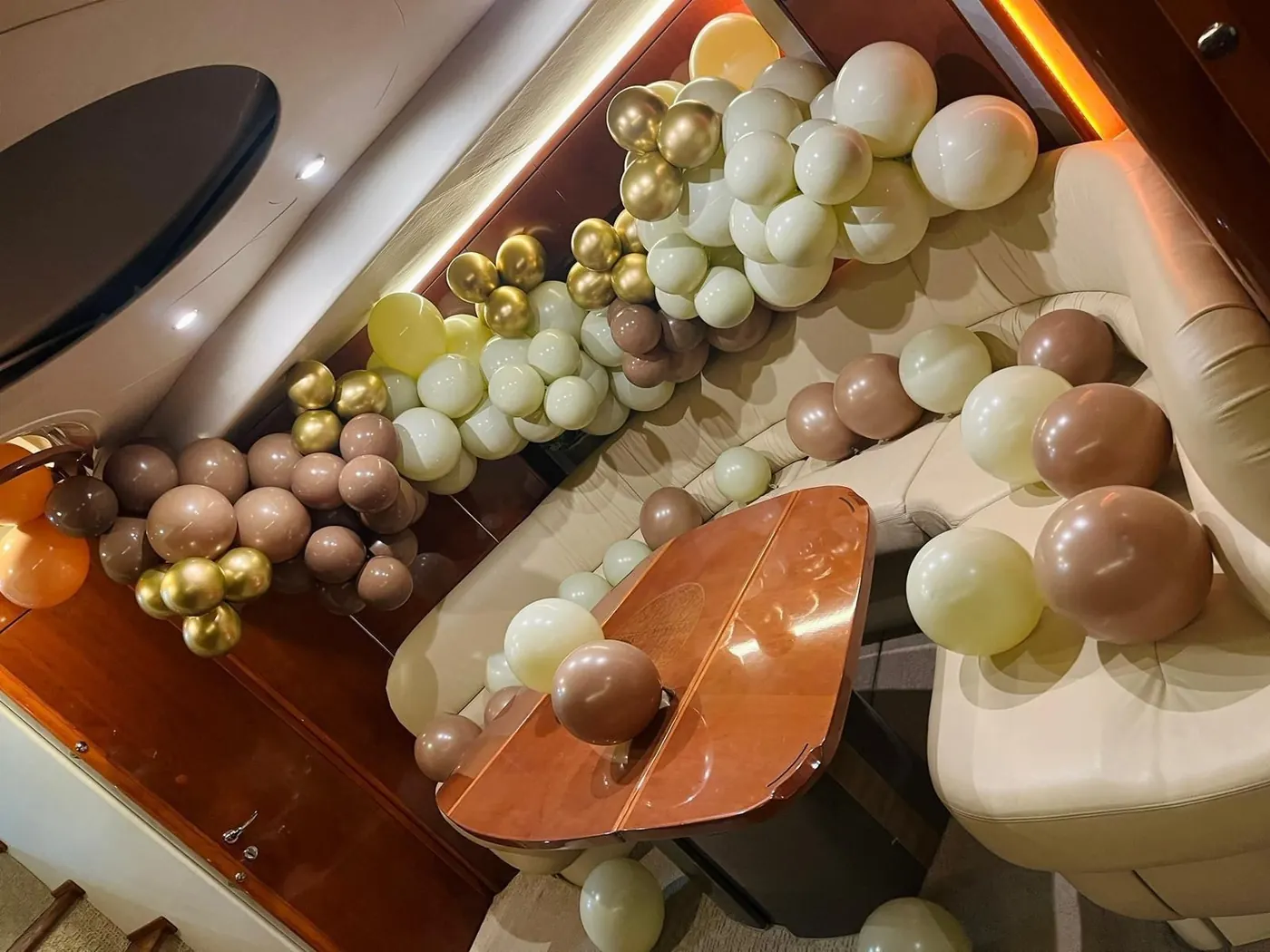 Themed brown gold and ivory balloon garland onboard yacht