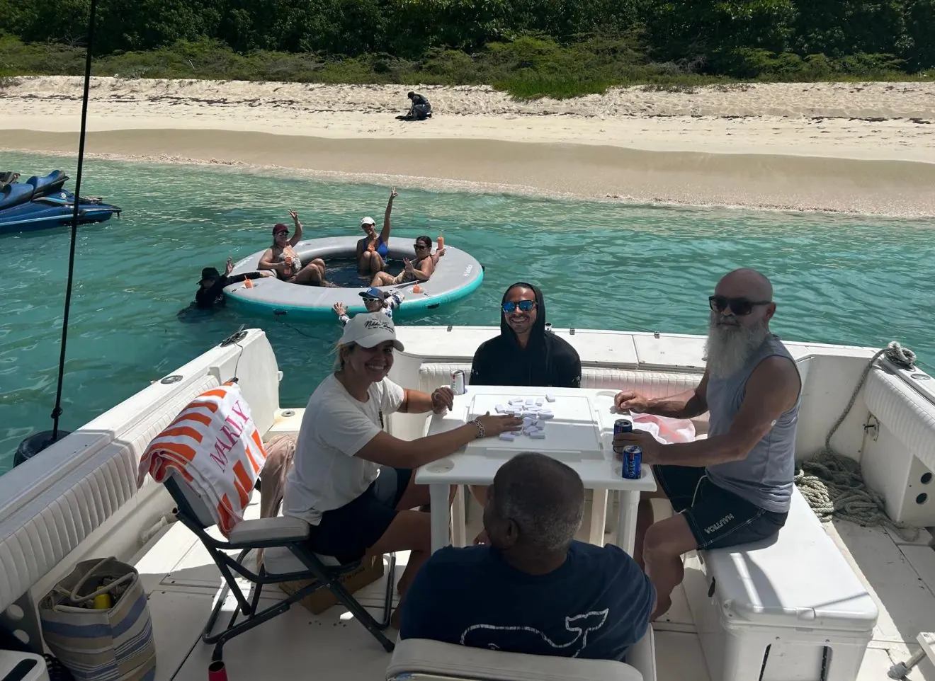 Guests playing dominoes on back deck at Icacos beach