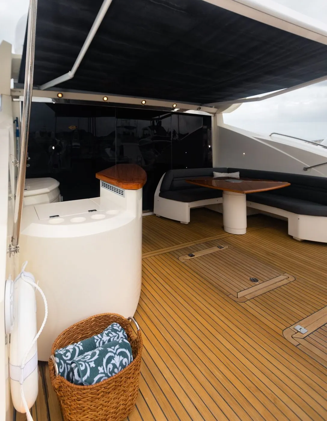 Aft deck dining under shaded awning with teak floors