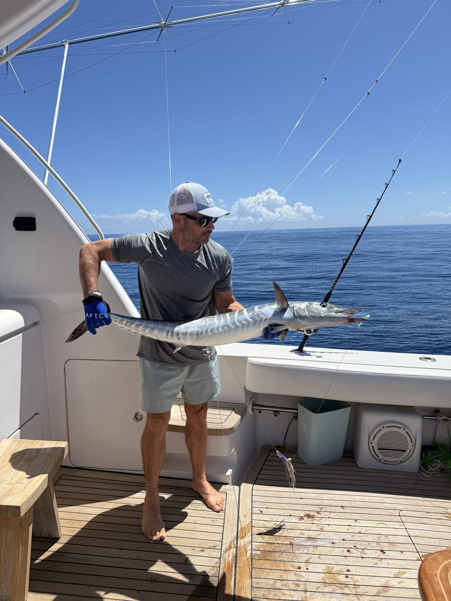 Wahoo catch held horizontally, deep Atlantic in the background