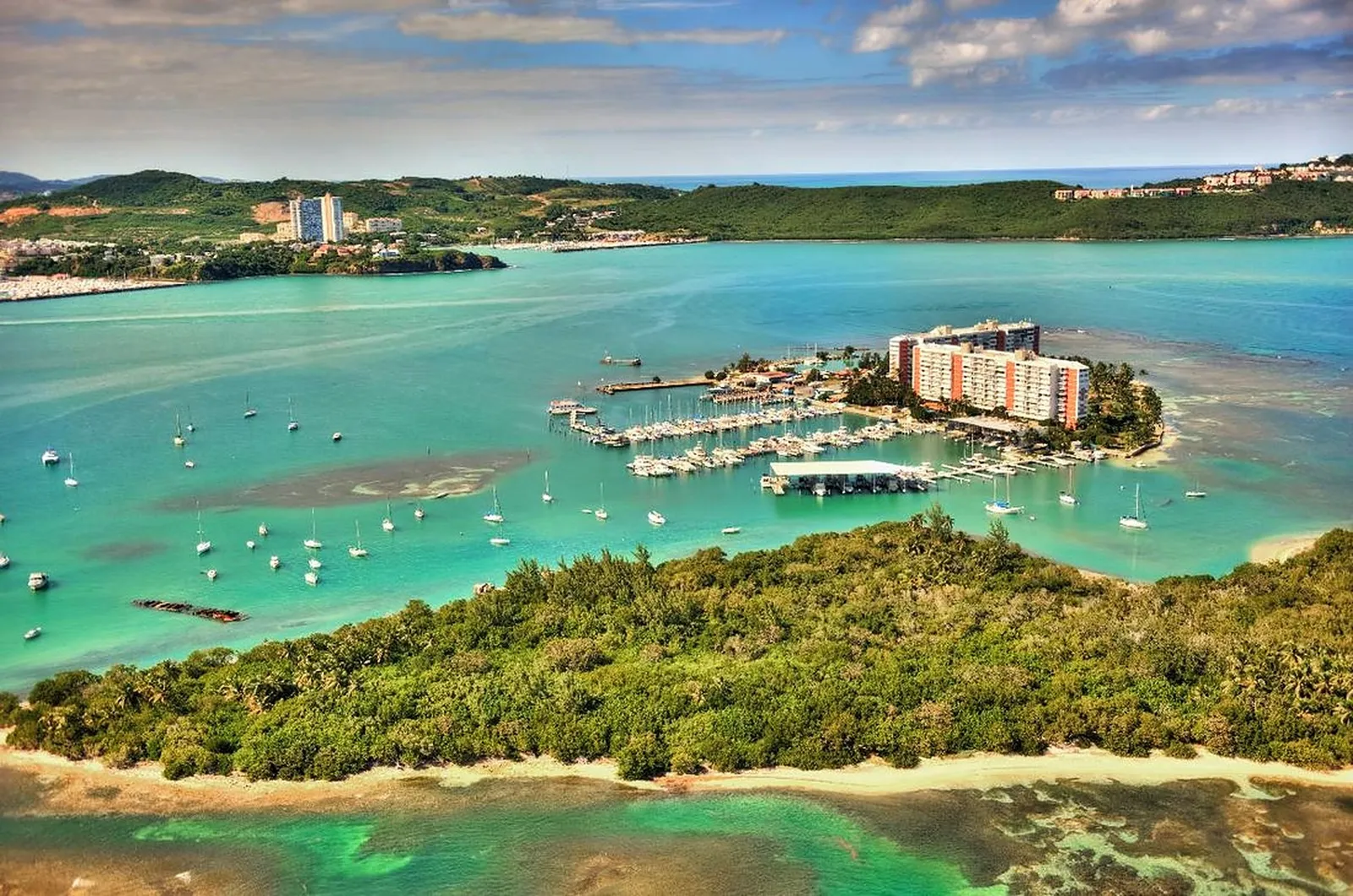 Aerial view of Isleta Marina (Cayo Obispo) showing the sheltered marina, anchored boats, and turquoise water near Fajardo, Puerto Rico
