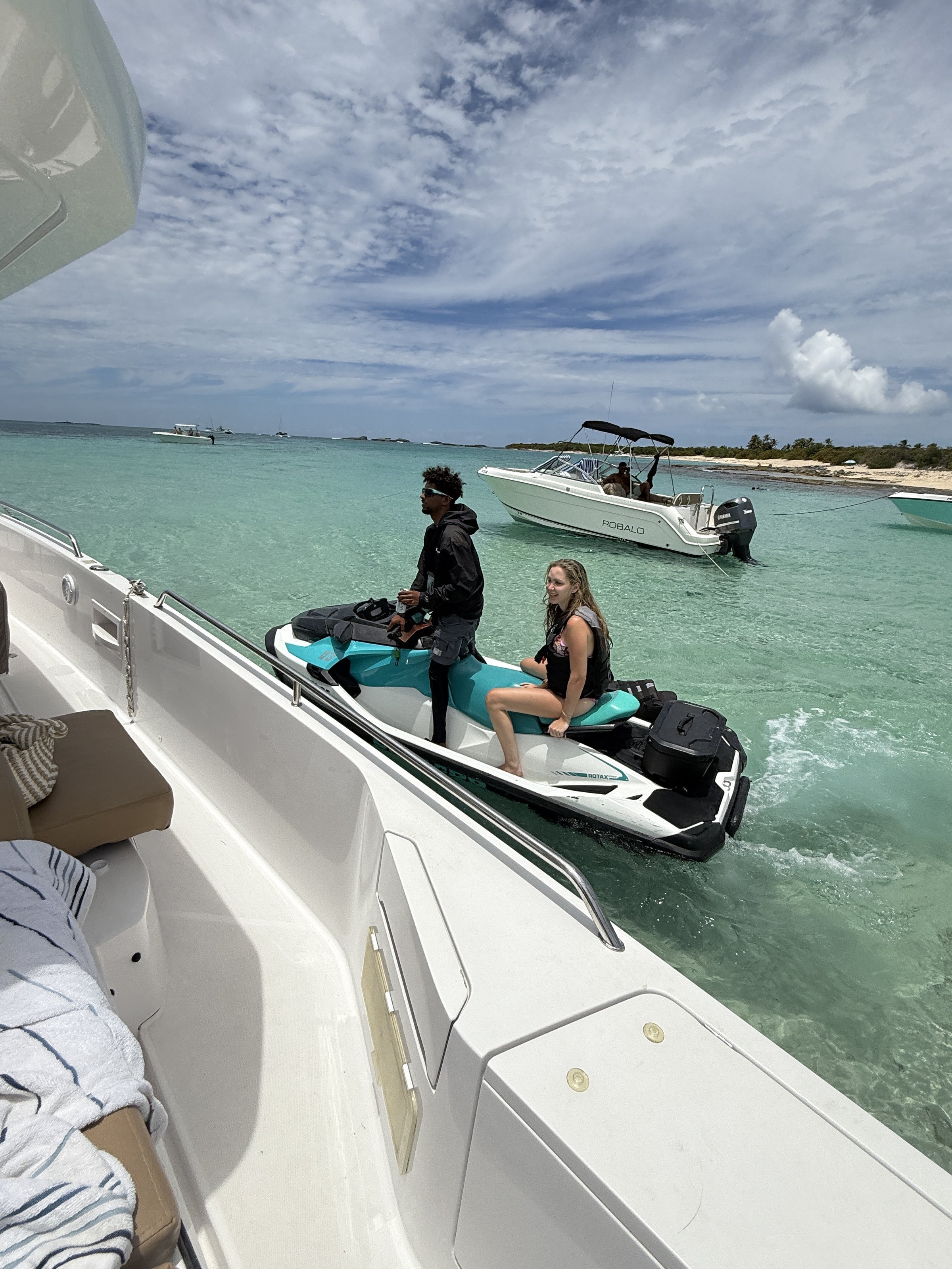 Sea-Doo jet ski tied to yacht with guests — delivered directly to your charter at the sandbar