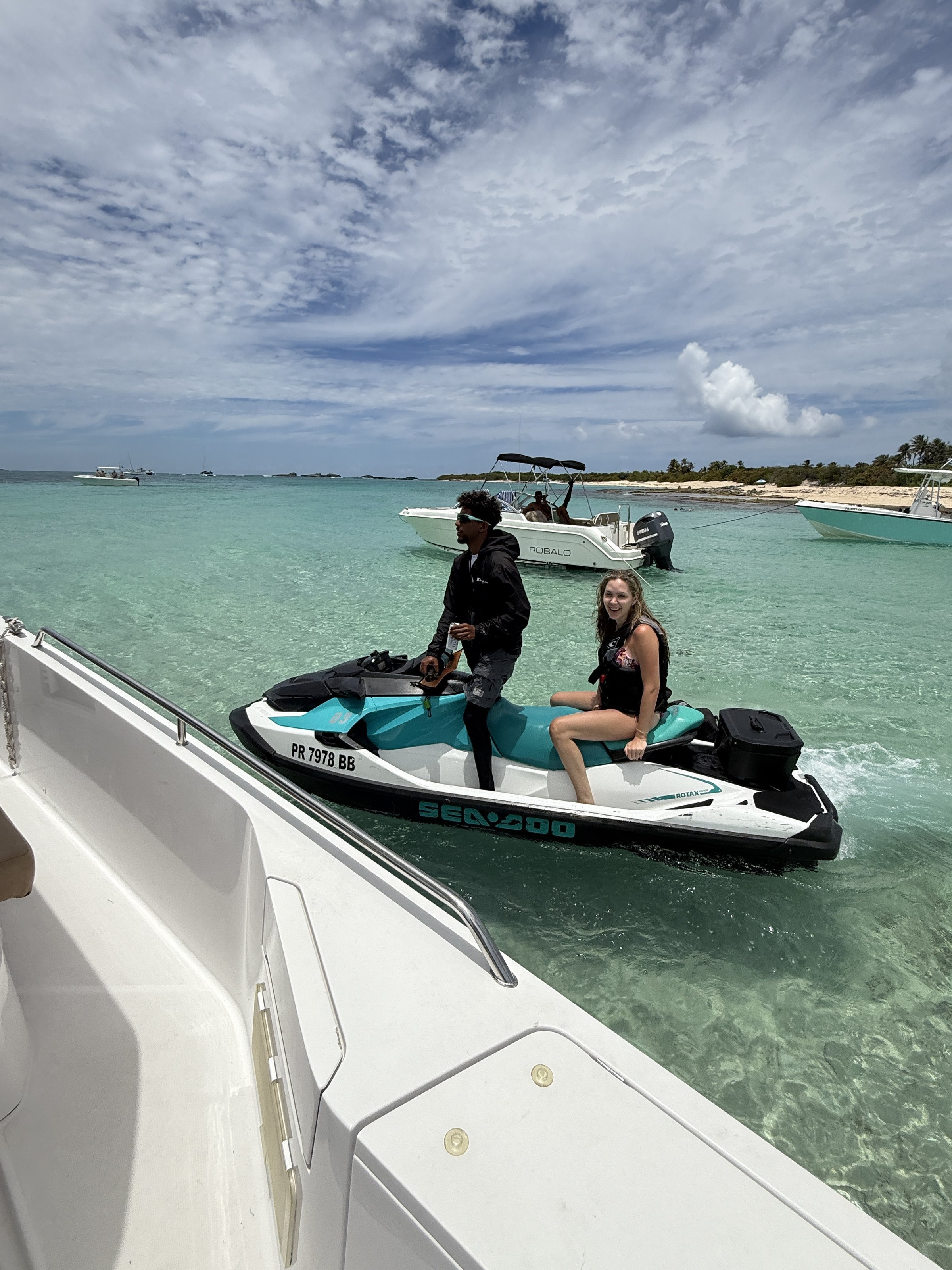 Sea-Doo jet ski rental at Cayo Icacos sandbar with captain and guest, anchored boats in the background — Boating Puerto Rico