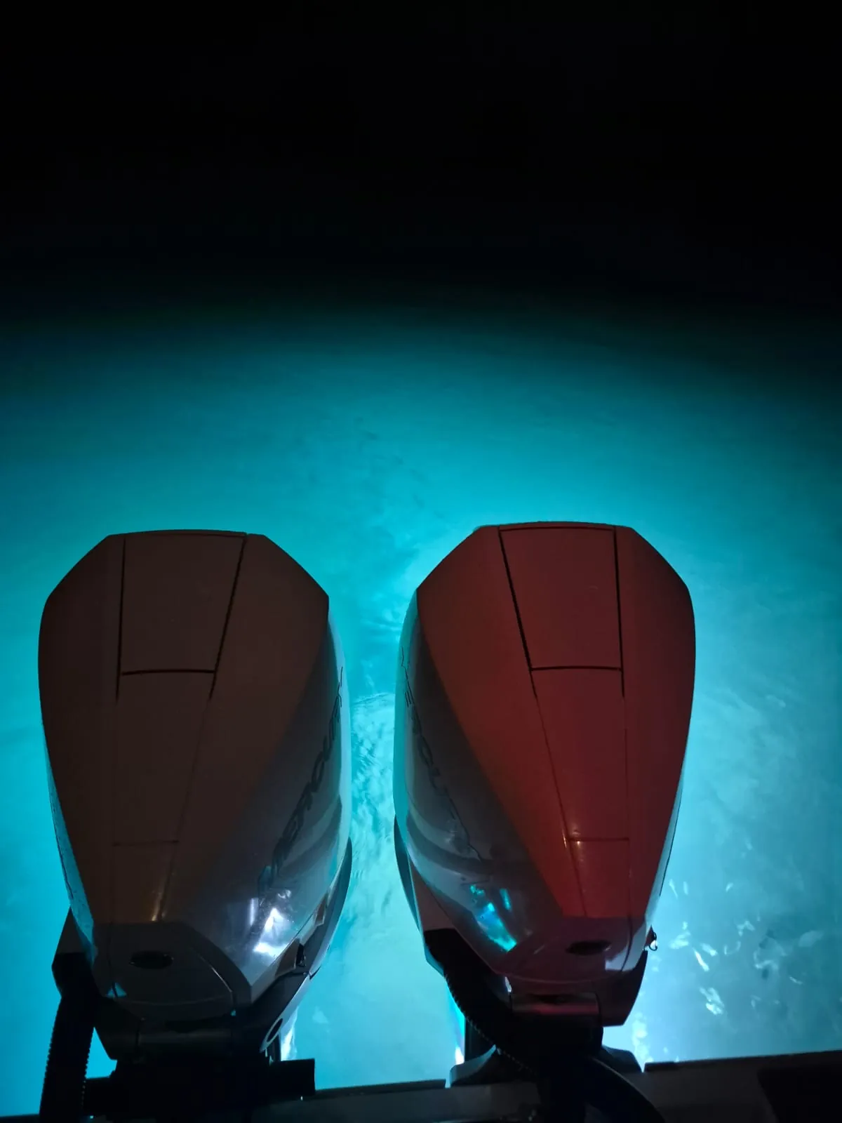 Close detail of the Contender 38 stern with the underwater lights lighting the sand bottom beneath the boat