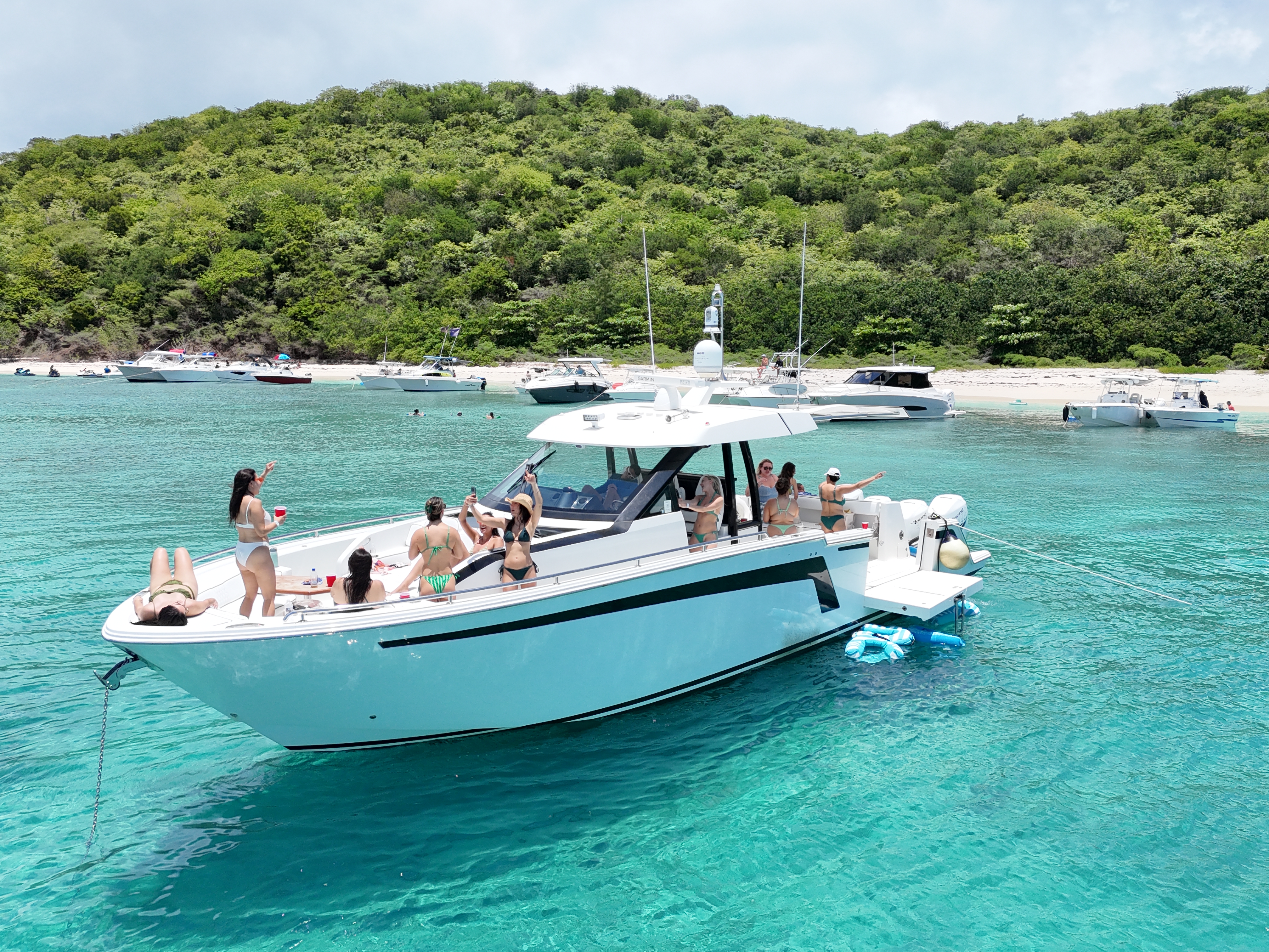 Ocean Alexander 45 sport yacht anchored at sandbar with guests celebrating onboard
