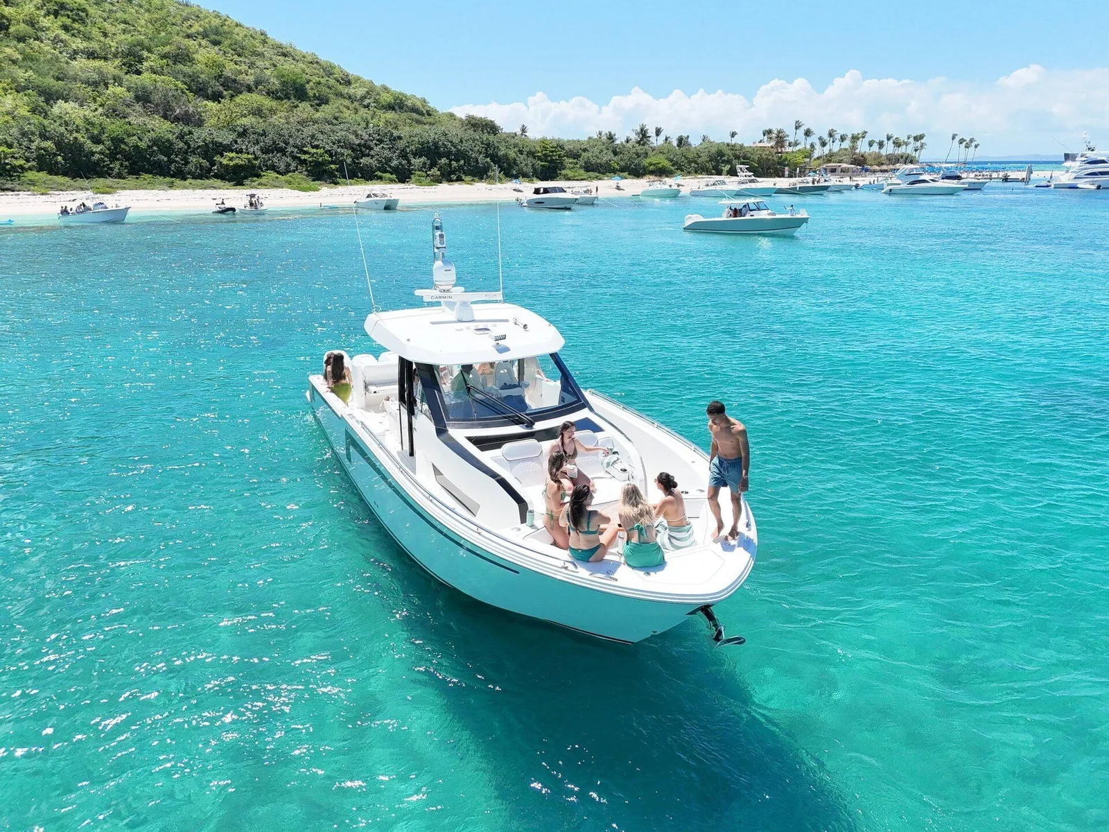 Aerial of Axopar yacht with guests on the bow anchored at a Caribbean sandbar