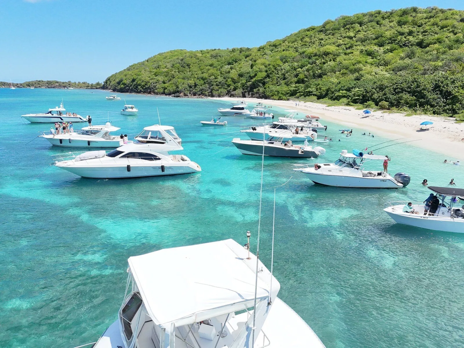 Aerial drone view of luxury yachts and boats lined up at Icacos beach in Puerto Rico