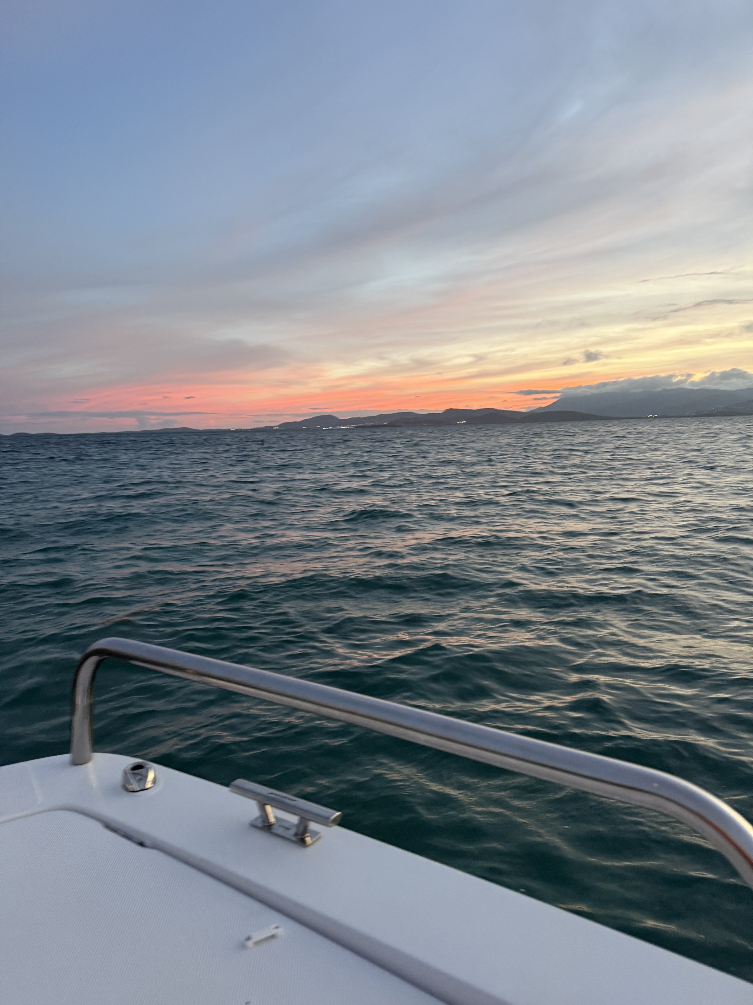 Group enjoying drinks on a private sunset boat charter