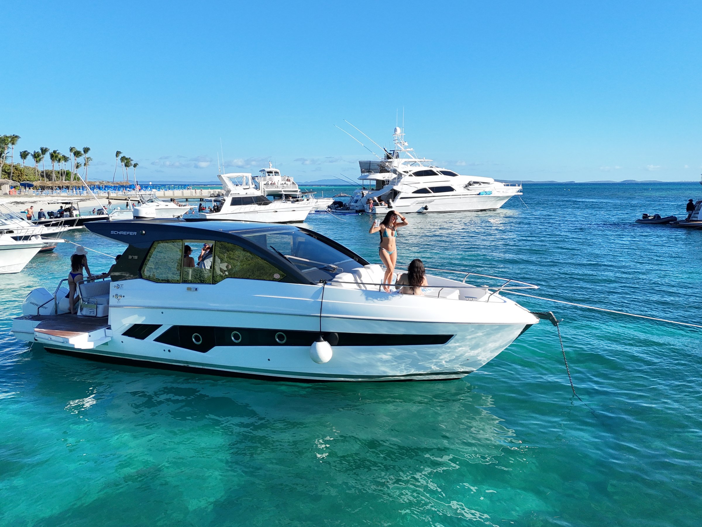Friends raising drinks at sunset on a private charter