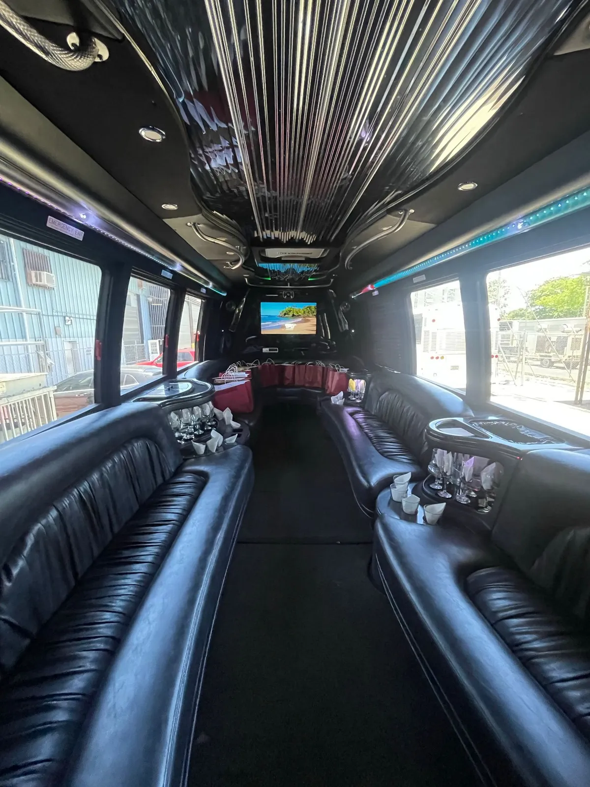 Interior of a private party bus with leather seating and bar setup, available for Puerto Rico group transportation