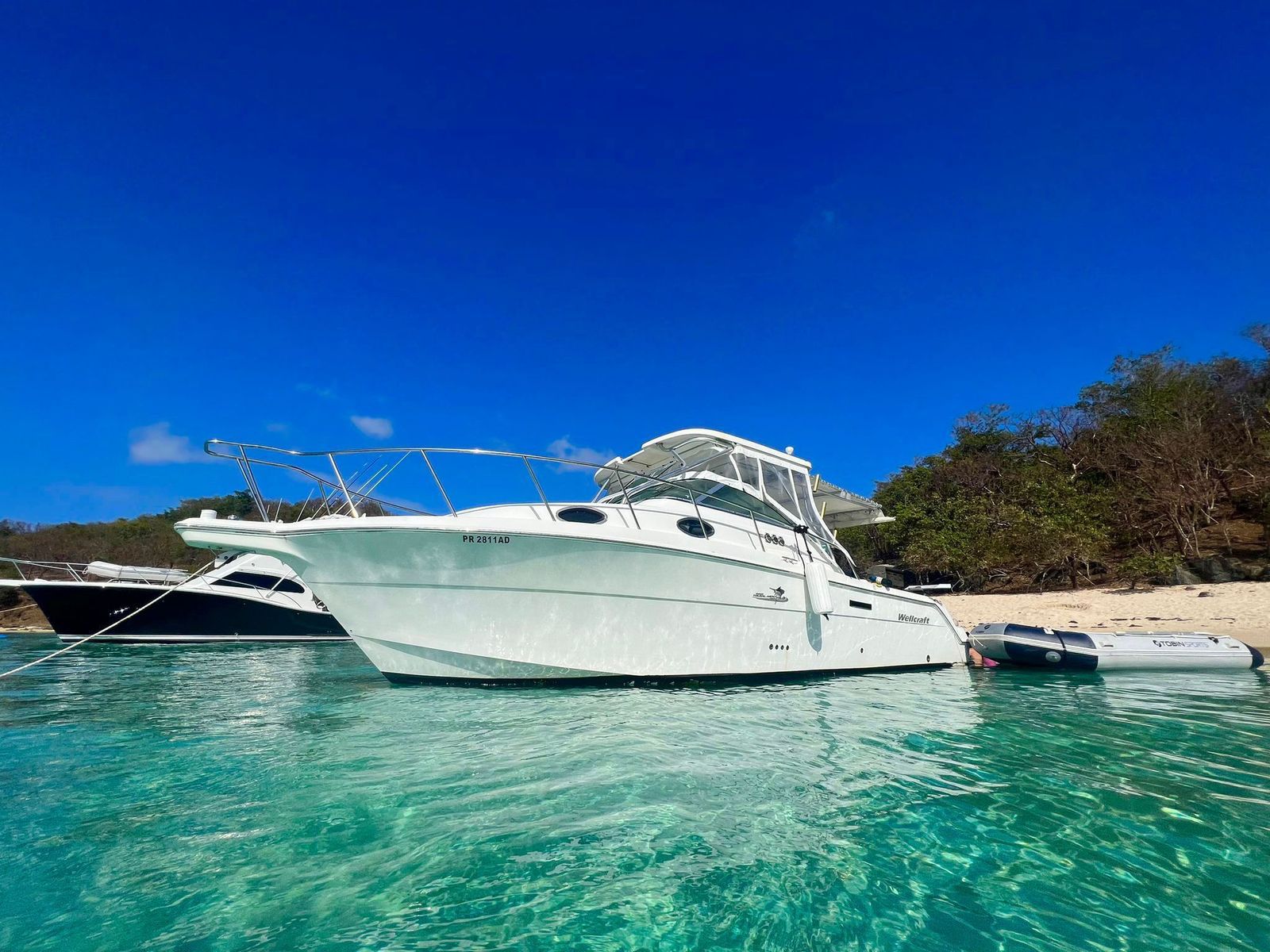 Wellcraft 30ft anchored at a Caribbean beach with crystal turquoise water