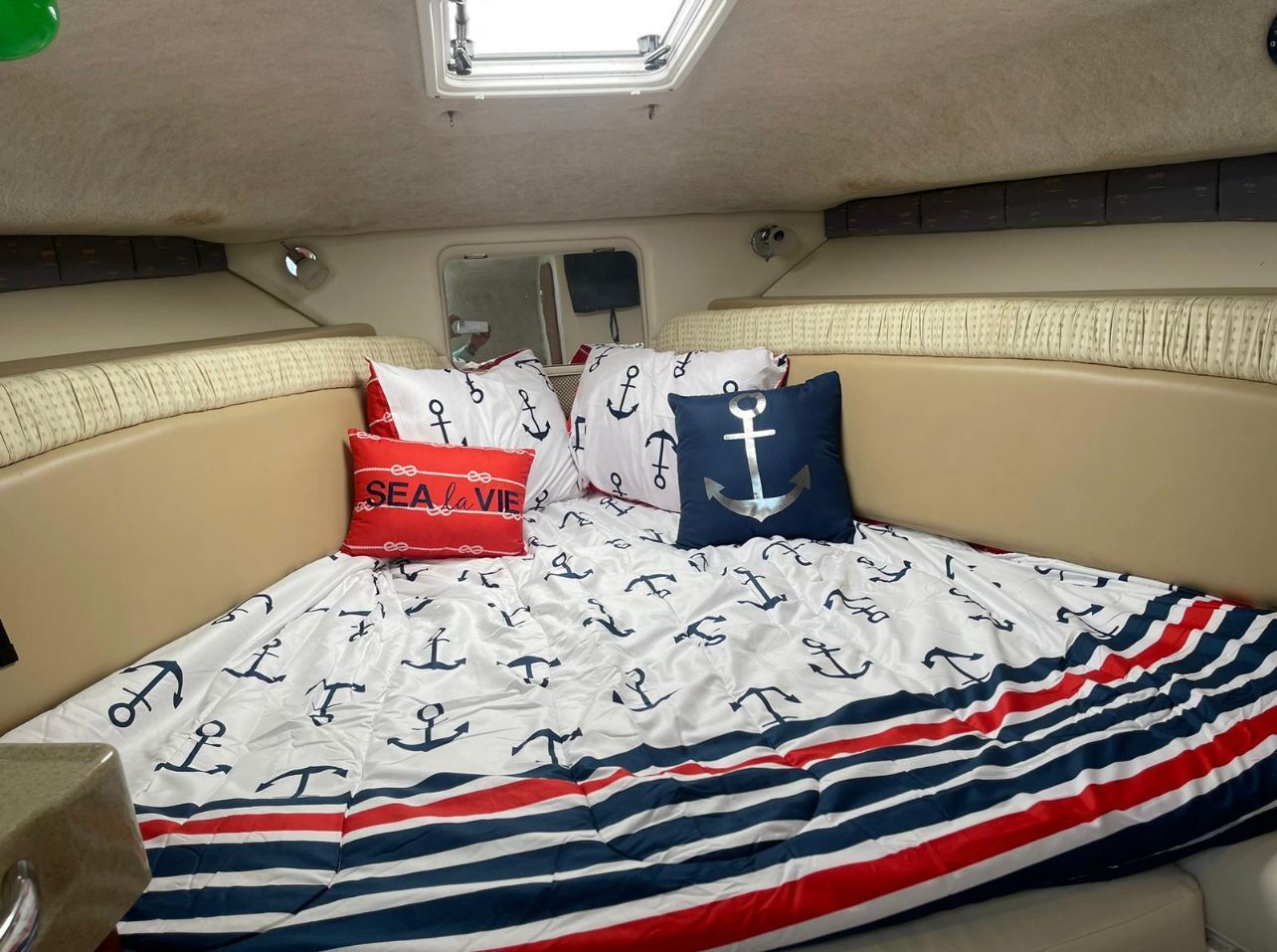 Wellcraft 30 cabin with anchor-print bedding and queen bed